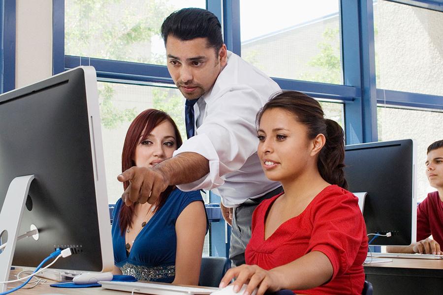 An instructor working with Teacher Education students